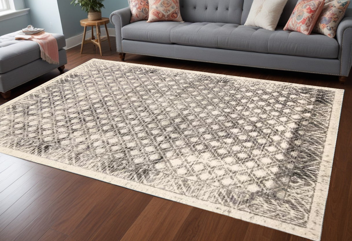 5' X 8' Ivory Black And Taupe Abstract Stain Resistant Area Rug