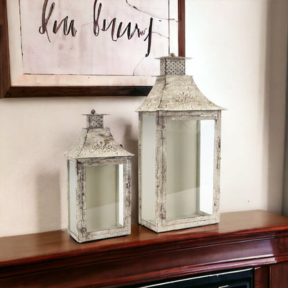 Set of Two Beige Distressed Filigree Iron And Glass Floor Lantern Candle Holders