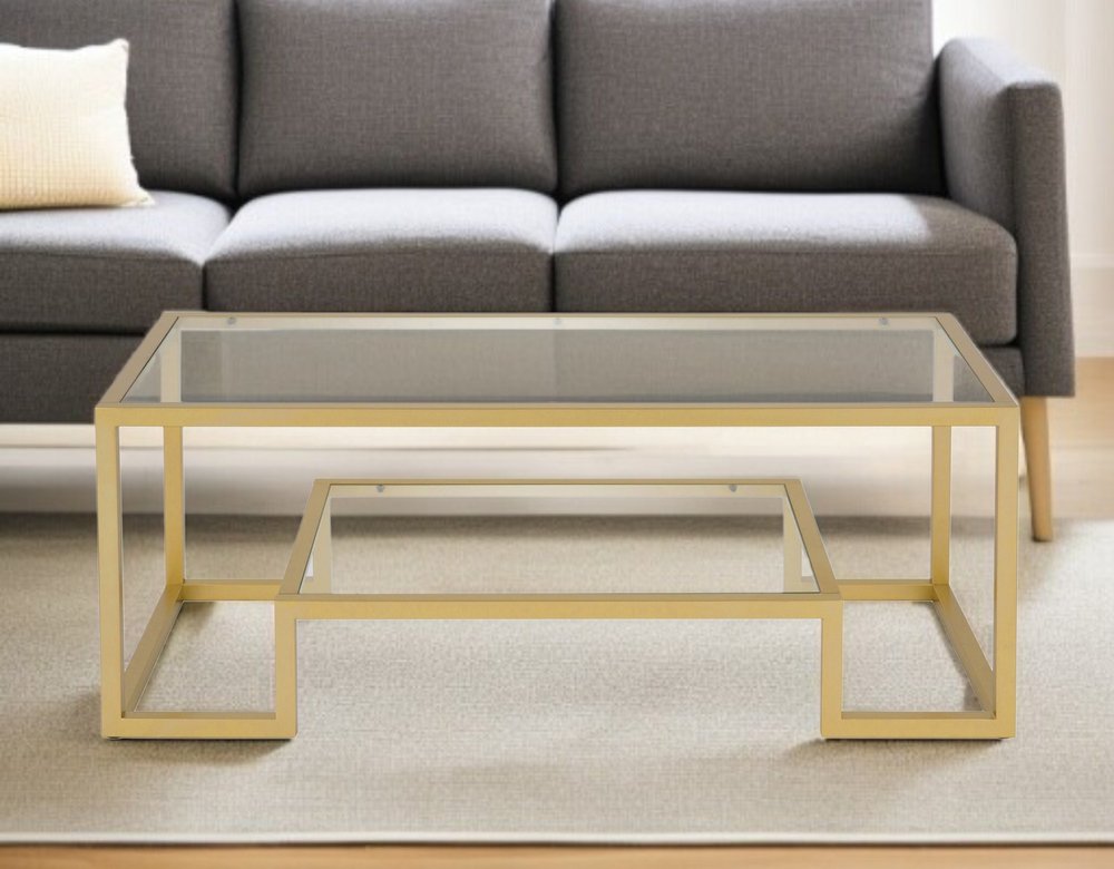 45" Clear And Gold Glass And Steel Sled Coffee Table With Shelf