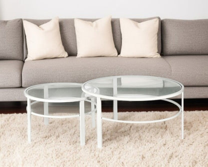 Set of Two 36" White Glass And Steel Round Nested Coffee Tables
