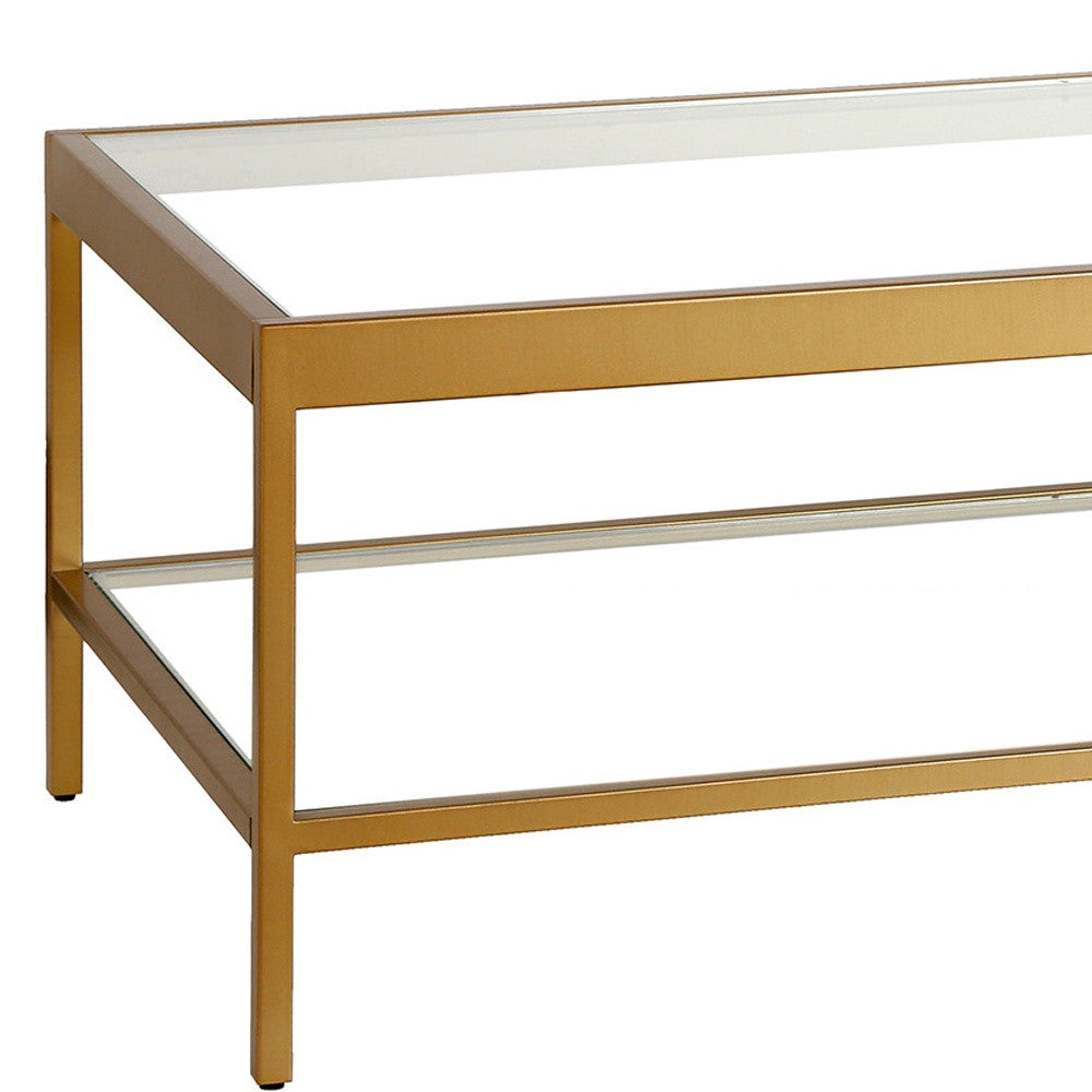 54" Clear And Gold Glass And Steel Coffee Table With Shelf