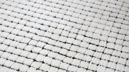 5' X 8' Beige and Black Checkered Power Loom Distressed Area Rug