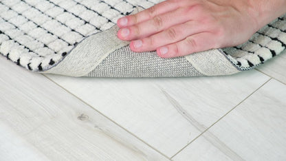 5' X 8' Beige and Black Checkered Power Loom Distressed Area Rug