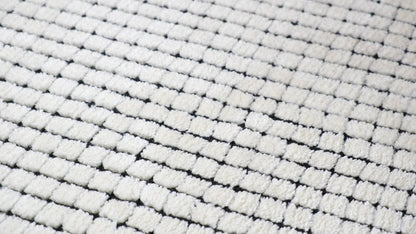 5' X 8' Beige and Black Checkered Power Loom Distressed Area Rug