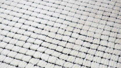 5' X 8' Beige and Black Checkered Power Loom Distressed Area Rug