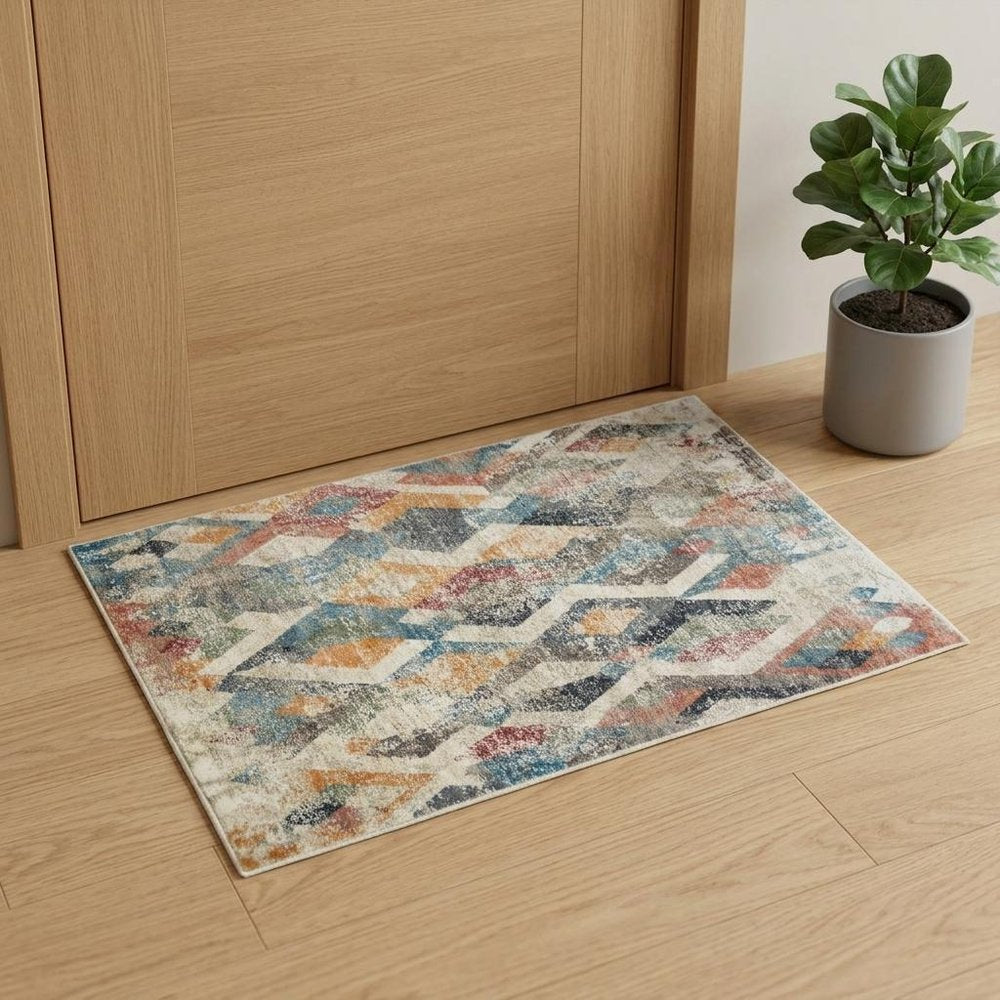 2' X 3' Beige Blue and Gray Geometric Distressed Area Rug With Fringe