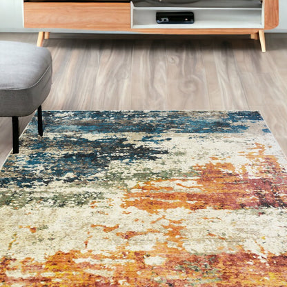 5' X 8' Beige Blue and Ivory Abstract Distressed Area Rug With Fringe