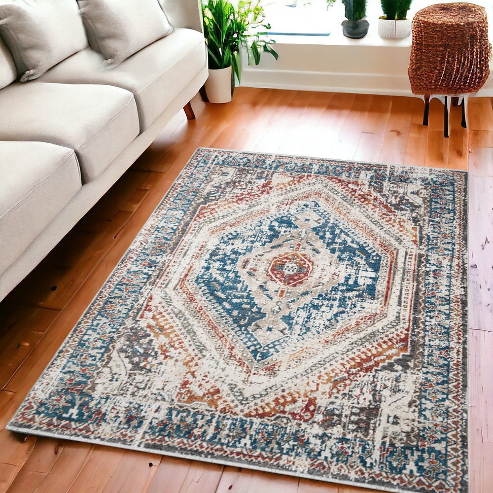 5' X 8' Teal Taupe and Rust Geometric Distressed Area Rug With Fringe