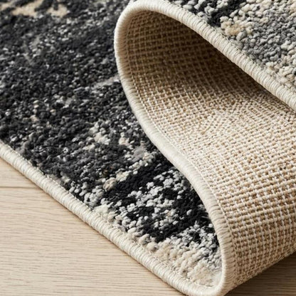 5' X 8' Beige and Black Abstract Distressed Area Rug