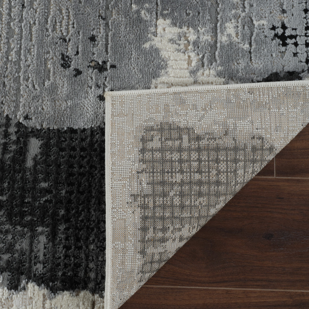 5' X 8' Beige and Black Abstract Distressed Area Rug