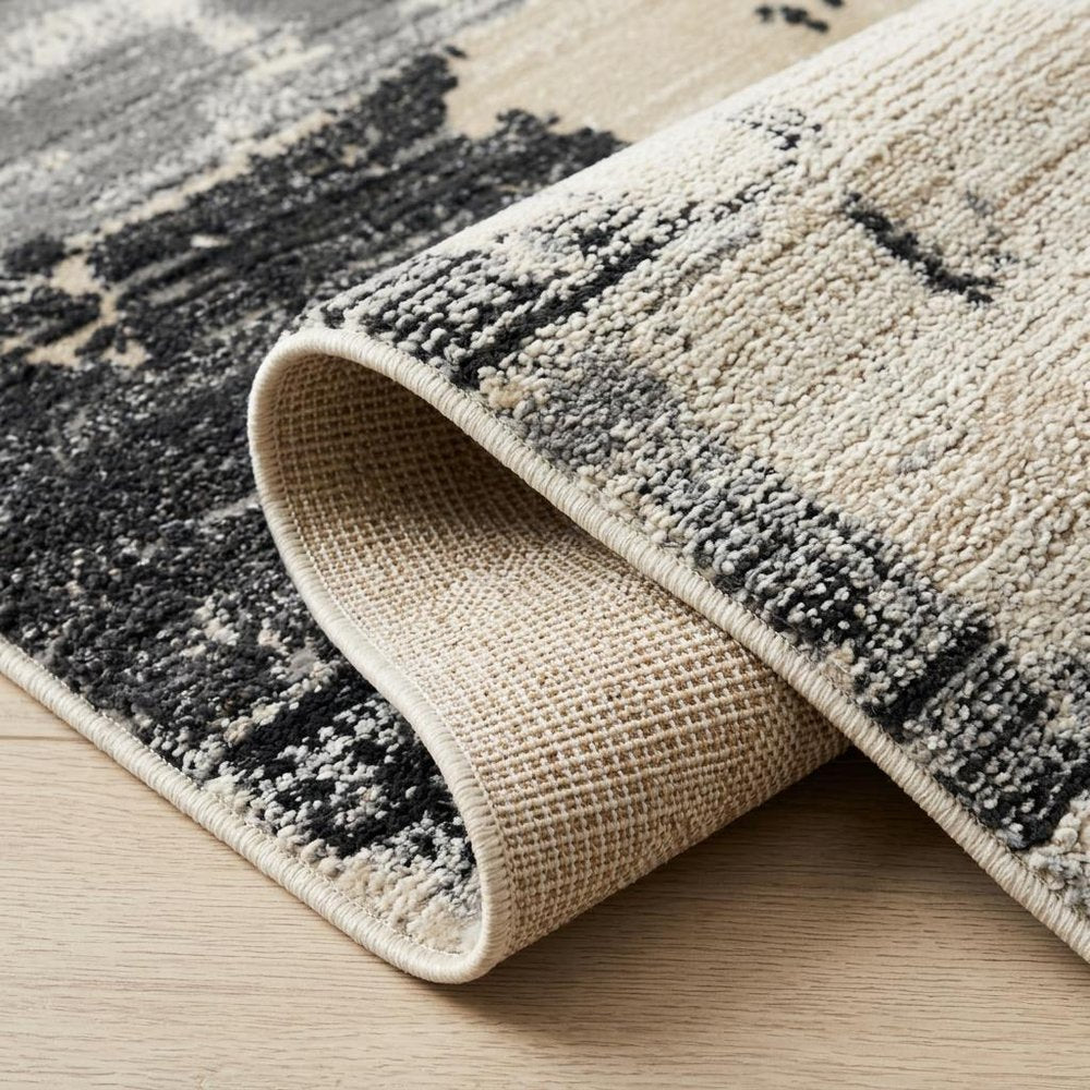 5' X 8' Beige and Black Abstract Distressed Area Rug