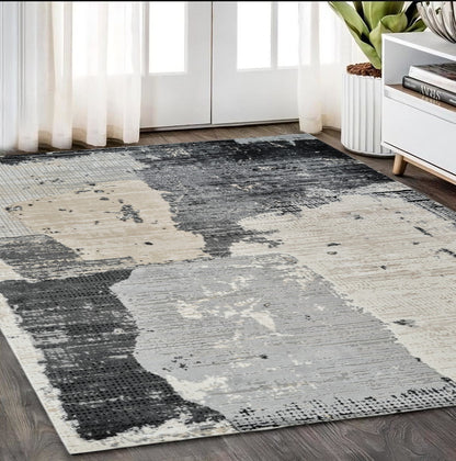 5' X 8' Beige and Black Abstract Distressed Area Rug