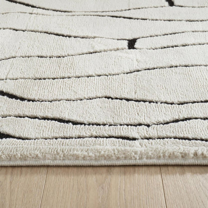 5' X 8' Cream and Black Abstract Distressed Area Rug
