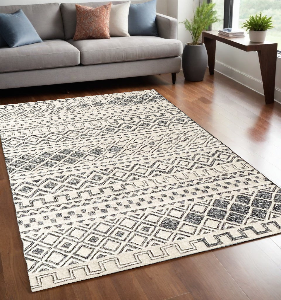 5' X 8' Black and Ivory Wool Abstract Geometric Hand Tufted Non Skid Area Rug